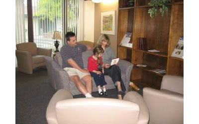 Katie and her parents sitting in the main lobby area.